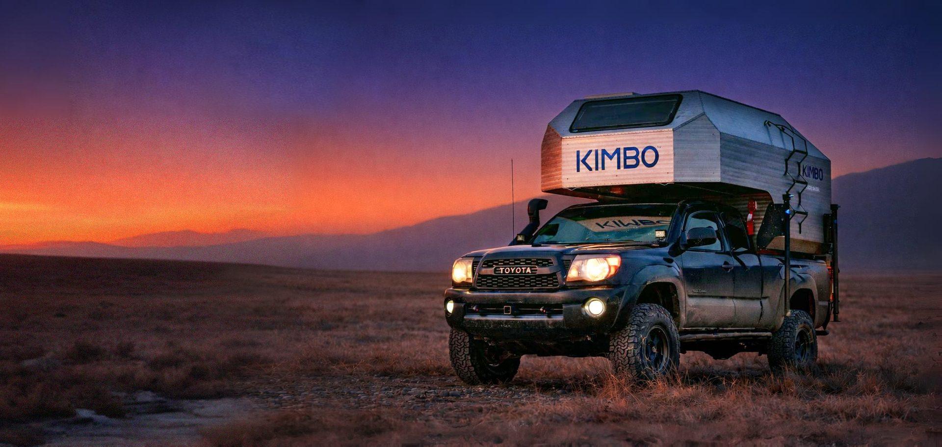 Kimbo aluminum truck camper at desert sunset